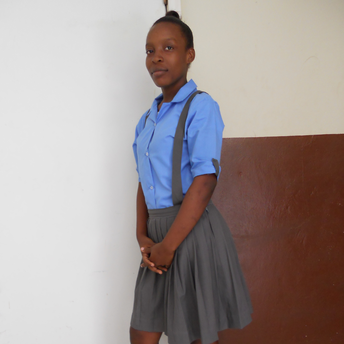 Jasmine in school uniform at Les Bons Samaritains
