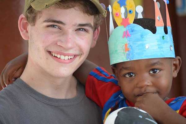 Young man holding a little boy