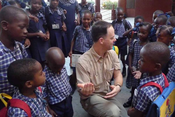 Man talking with primary school kids